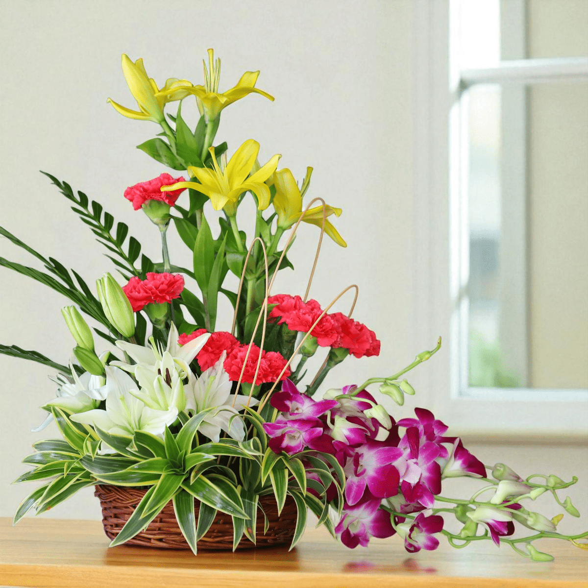 Exotic flower basket arrangement with lilies, orchids & carnations