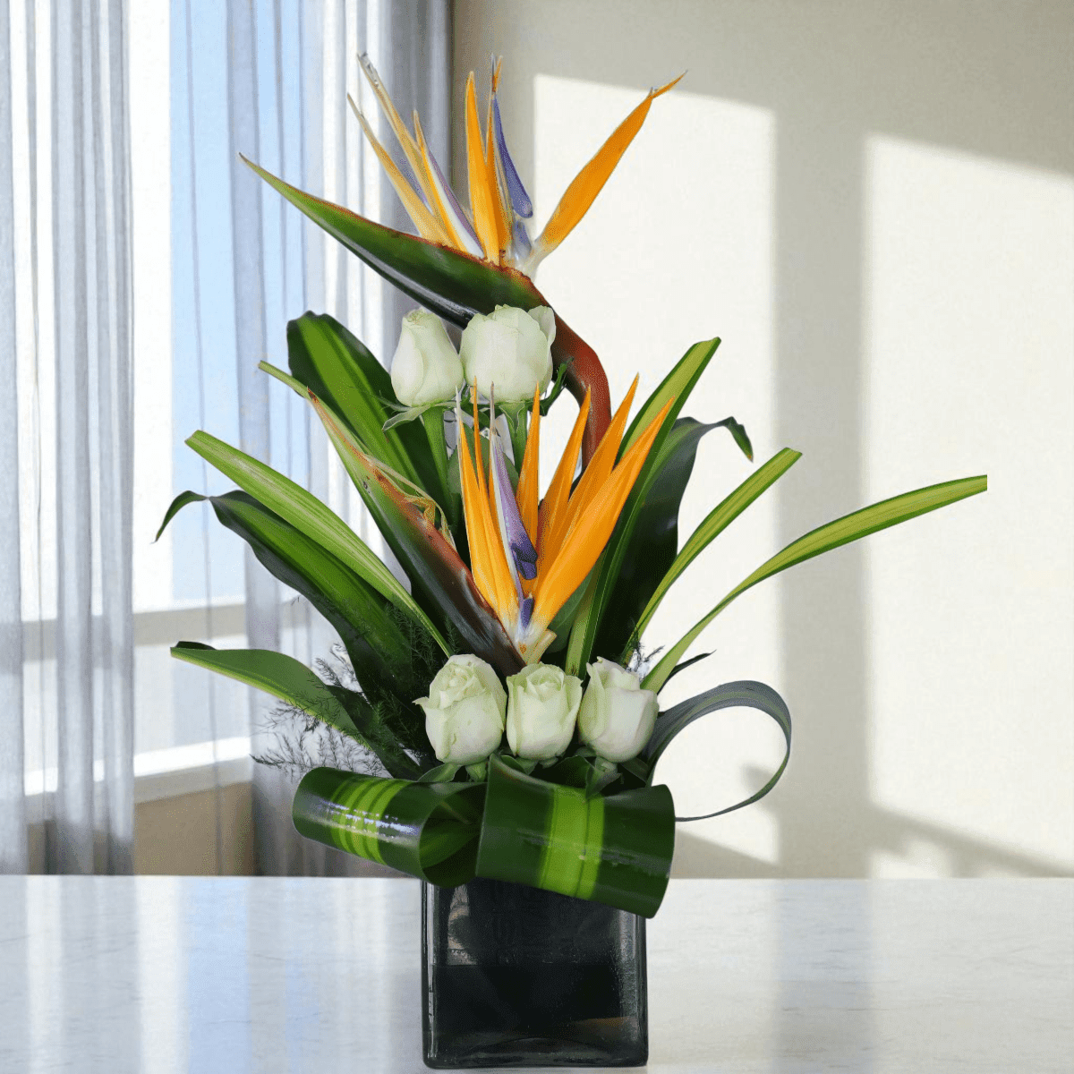 White Roses and Bird of Paradise Flower Arrangement in 4x4 Inch Glass Vase White Roses and Bird of Paradise Flower Arrangement in 4x4 Inch Glass Vase