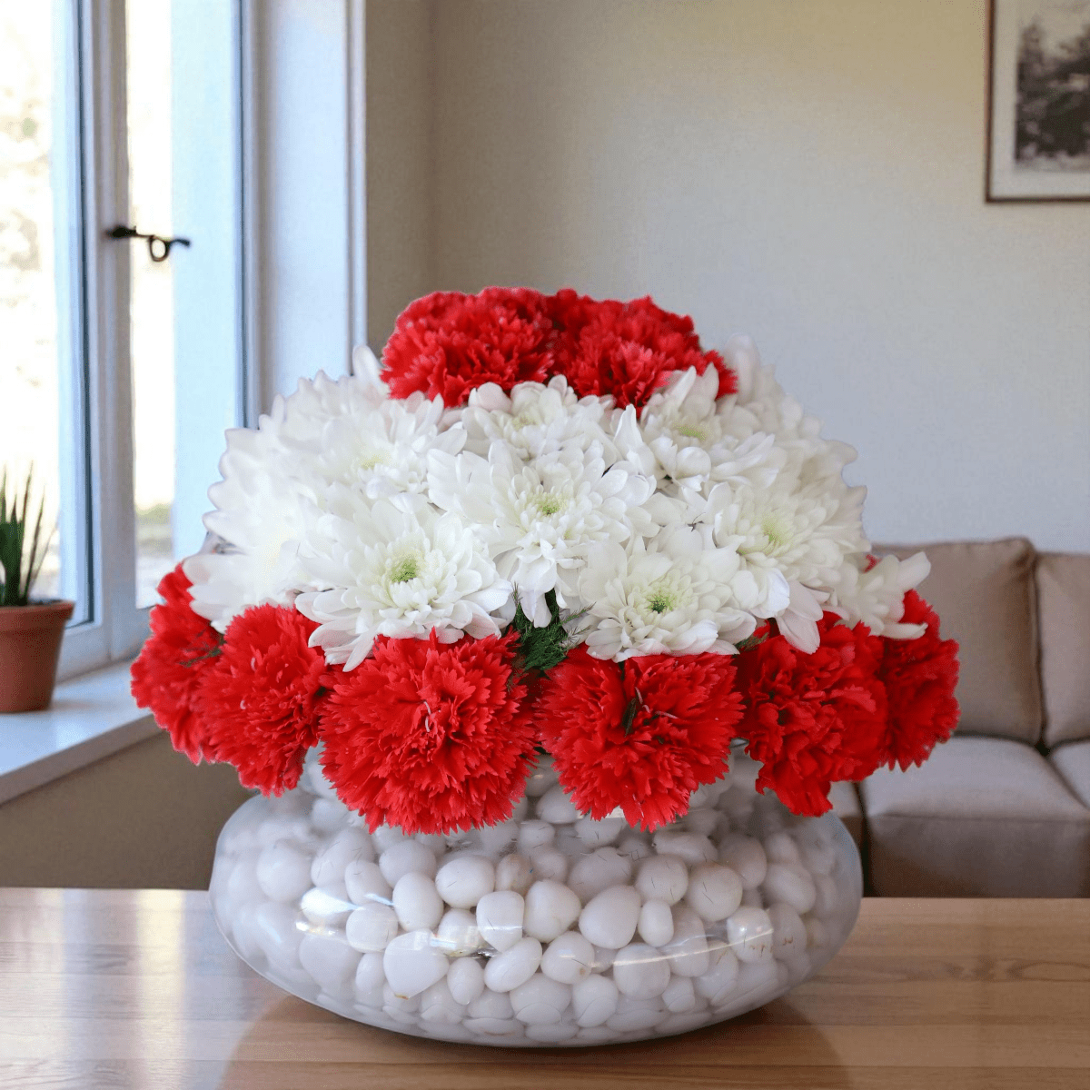 Crimson Snow Harmony red carnation flower arrangement in round glass vase