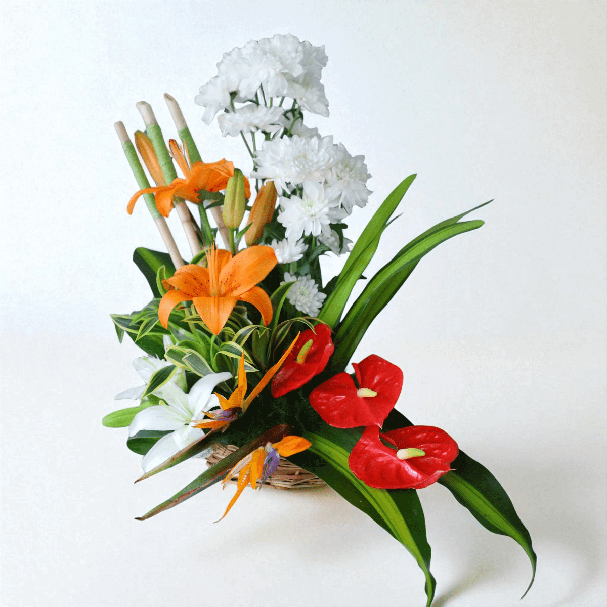 Exotic flower basket arrangement with lilies, orchids & anthuriums