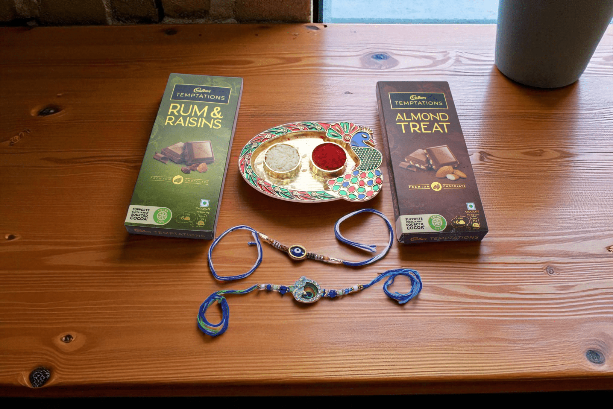 one Krishna rakhi, one evil eye rakhi, Cadbury Temptations – Rum & Raisins and Almond Treat, - YHOJA.COM