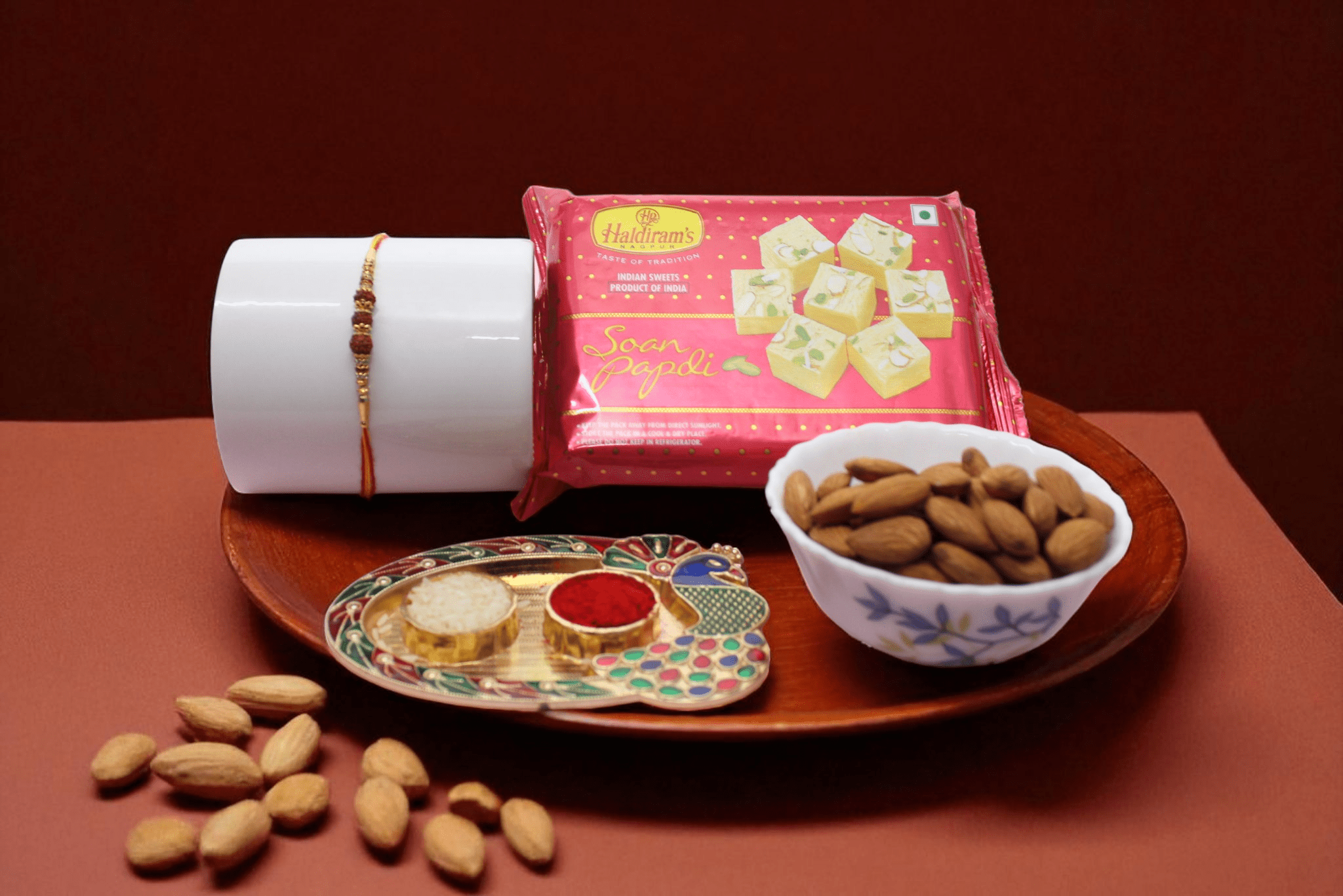 Rudraksh Rakhi Dry Fruit Hamper Rudraksh Rakhi Dry Fruit Hamper with Haldiram's Soan Papdi, Almonds and Roli Chawal Set