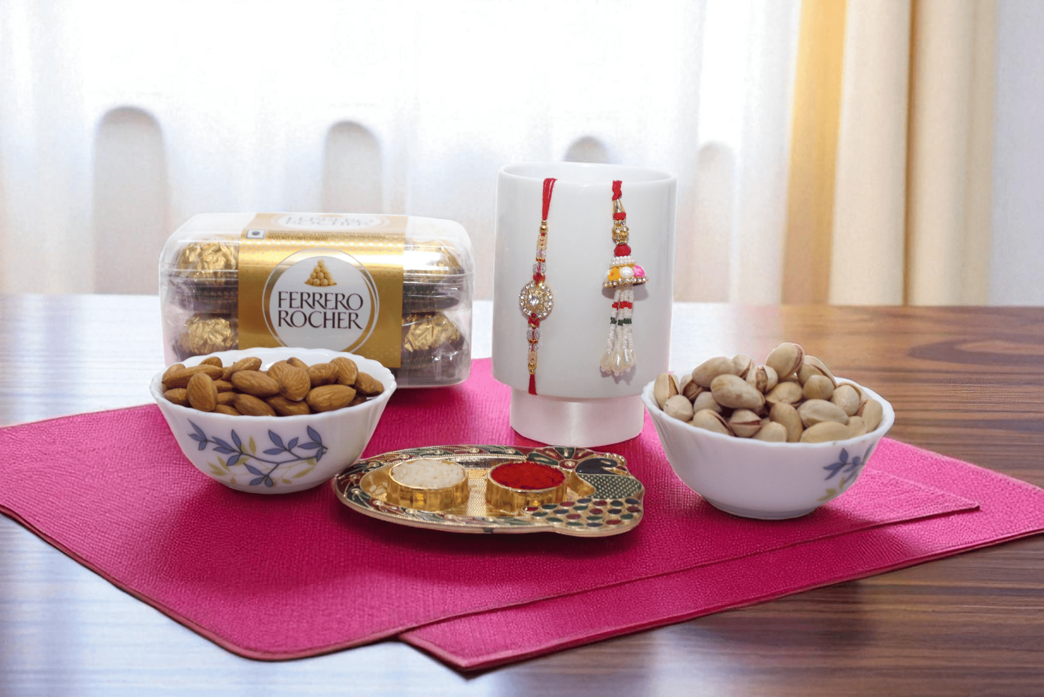 Rakhi With Chocolate & Dry Fruit Premium Bhaiya Bhabhi Rakhi gift hamper featuring Lumba Rakhi set, Ferrero Rocher chocolates, dry fruits in bowls, designer pooja thali with roli chawal, and Rakhi mug – elegant Raksha Bandhan combo for brother and sister-in-law - YHOJA.COM