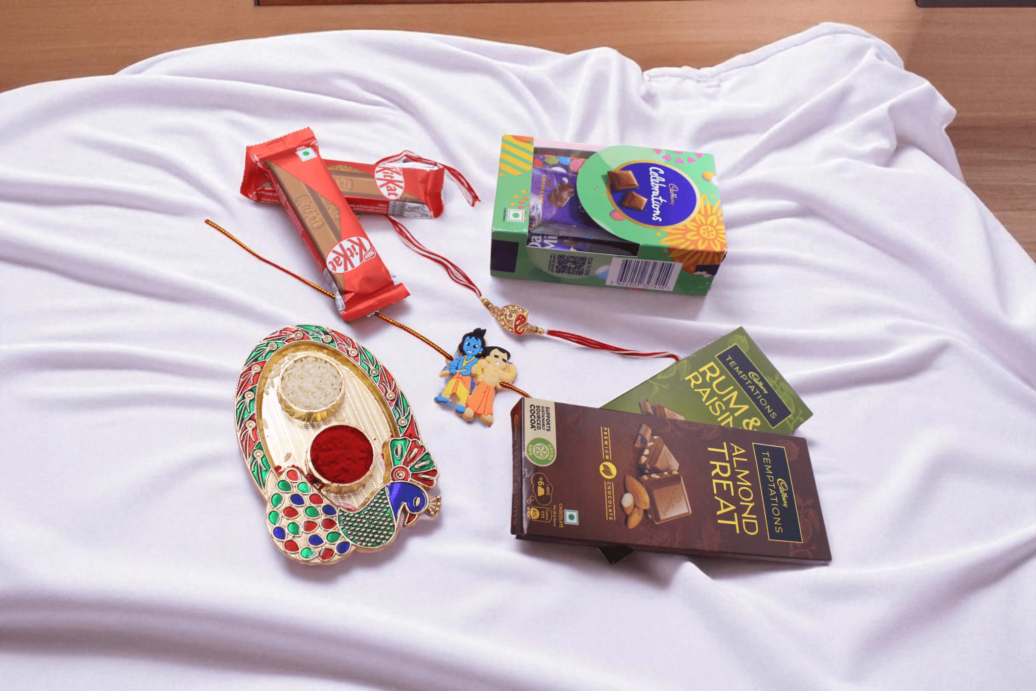 Kids Chocolate Rakhi Celebration Hamper with Krishna Rakhi, Ganpati Rakhi, Cadbury Celebrations, Temptations and KitKat