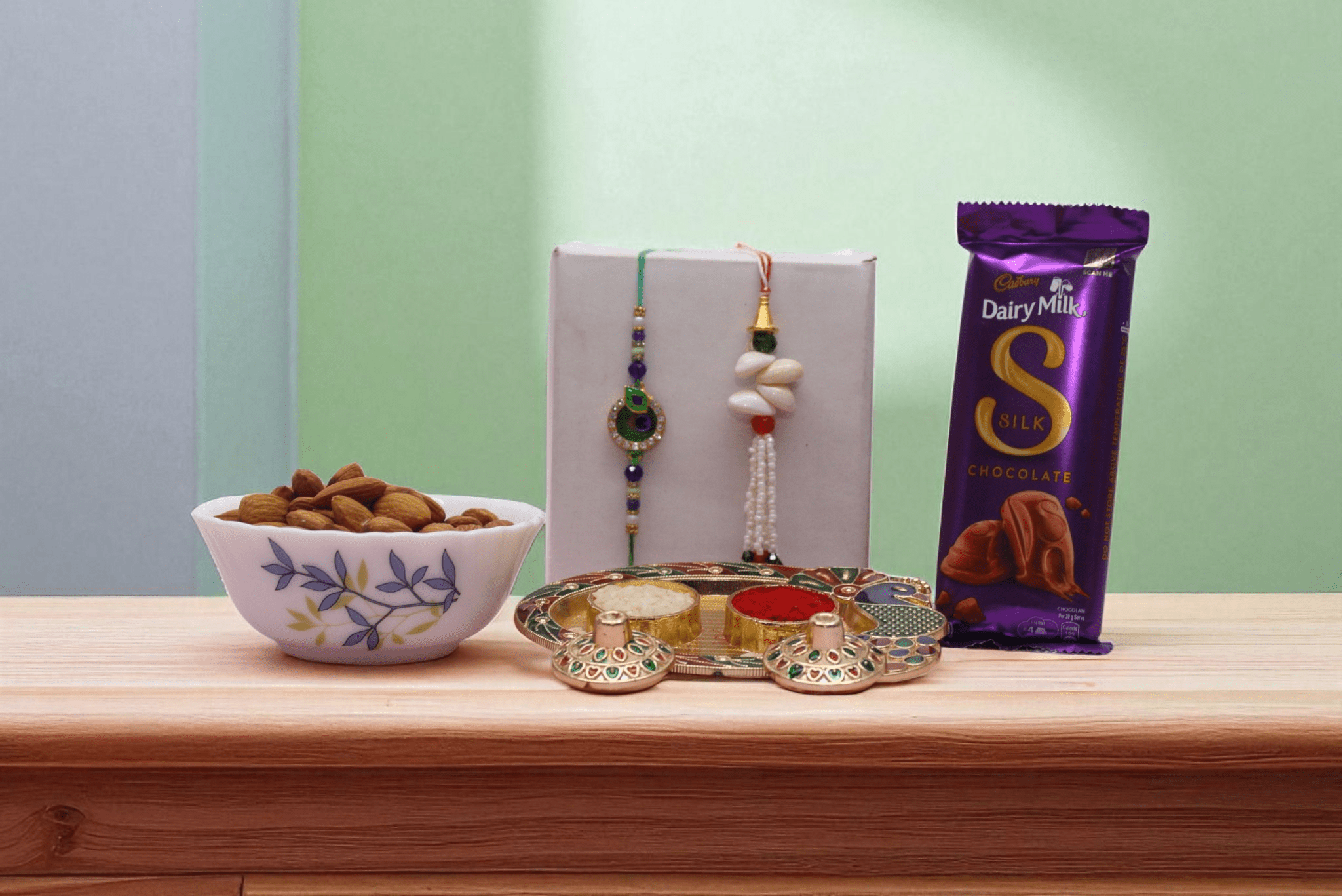 elegant Bhaiya-Bhabhi Rakhi set, 100g almonds, and a smooth, rich Dairy Milk Silk chocolate - YHOJA.COM