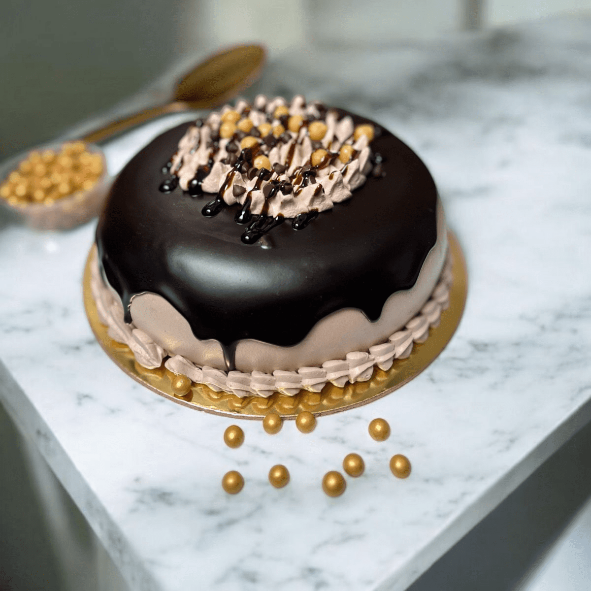 Choco Butterscotch Bliss Cake with glossy chocolate glaze and caramel pearl topping
