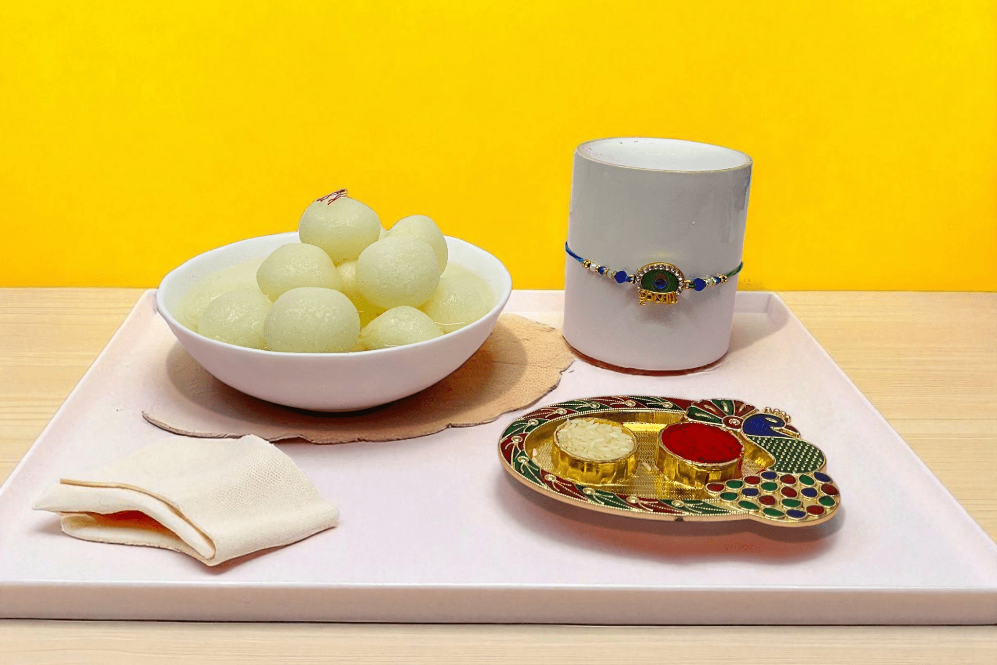 Rakhi With Rasgulla, Yhoja.com peacock Rakhi paired with 1kg soft and juicy rasgulla - YHOJA.COM