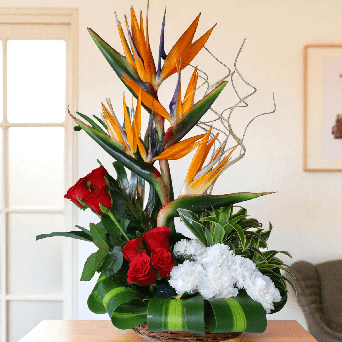 BOP and Rose Cane Basket Arrangement with Bird of Paradise, red roses, and white carnations.